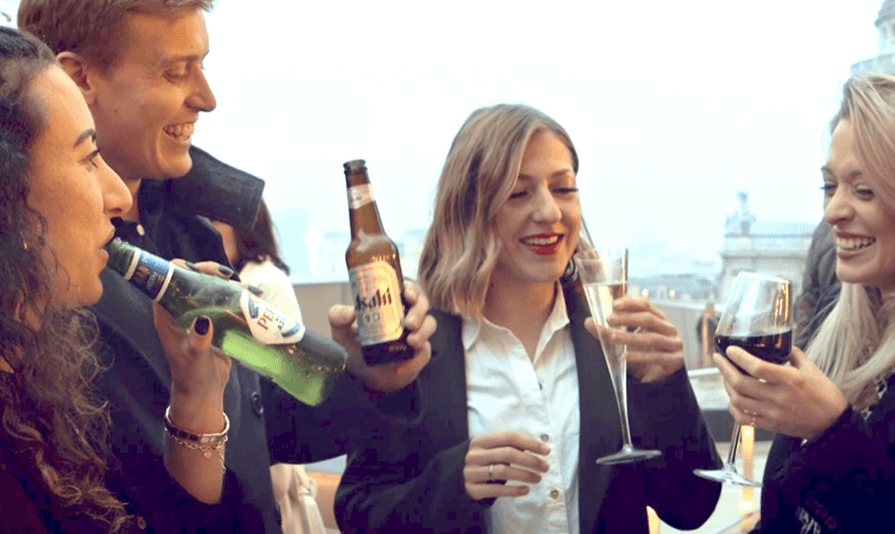 People celebrating with Asahi beverages